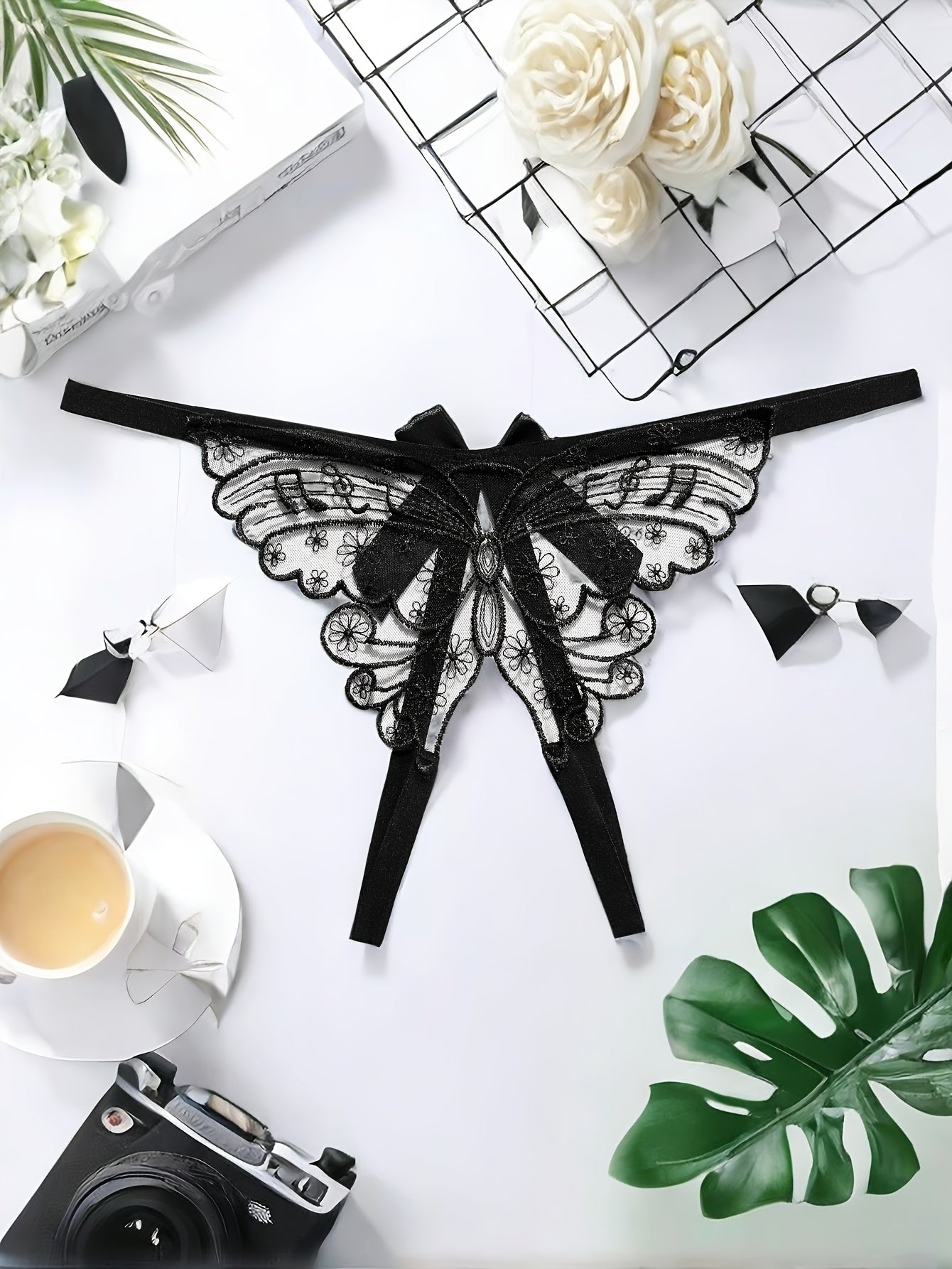 Adults' elegant butterfly embroidery mesh thong with split crotch and bow detail, made of knit fabric.