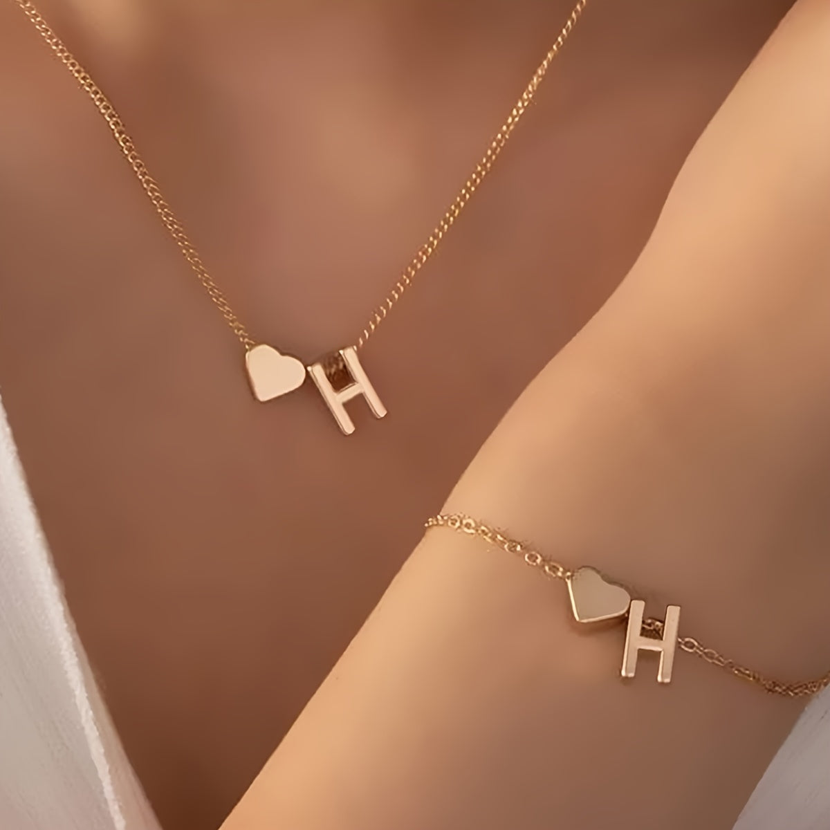 Chic two-piece set with metal heart and letter necklace and bracelet, ideal for daily wear.