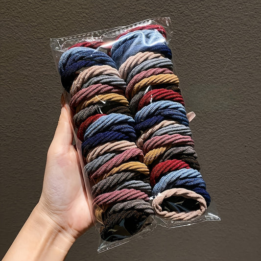 50 high elastic hair ties in vibrant mixed colors for women with assorted shades including red, blue, yellow, green, and purple. Durable and stretchy ponytail holders and hair bands