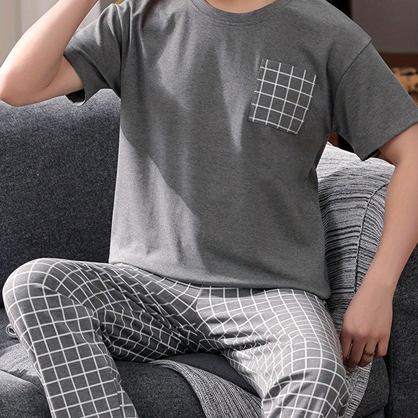 Men's 2-piece plaid pajama set includes round neck top and matching trousers for cozy loungewear comfort.