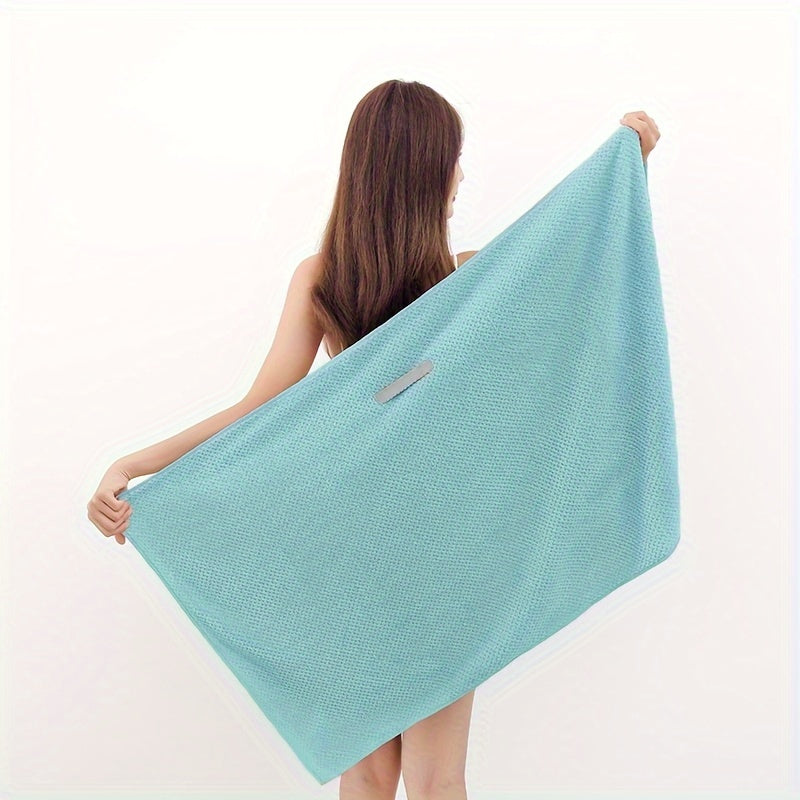 Fast-drying microfiber hair towel for women with long, thick, and curly hair. Soft coral fleece material with elastic band for everyday comfort. Beige textured design for quick drying.