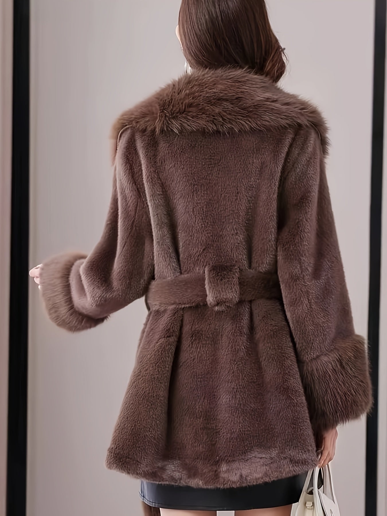 Stylish women's faux fur hooded coat with belt, long sleeves, and mid-length.