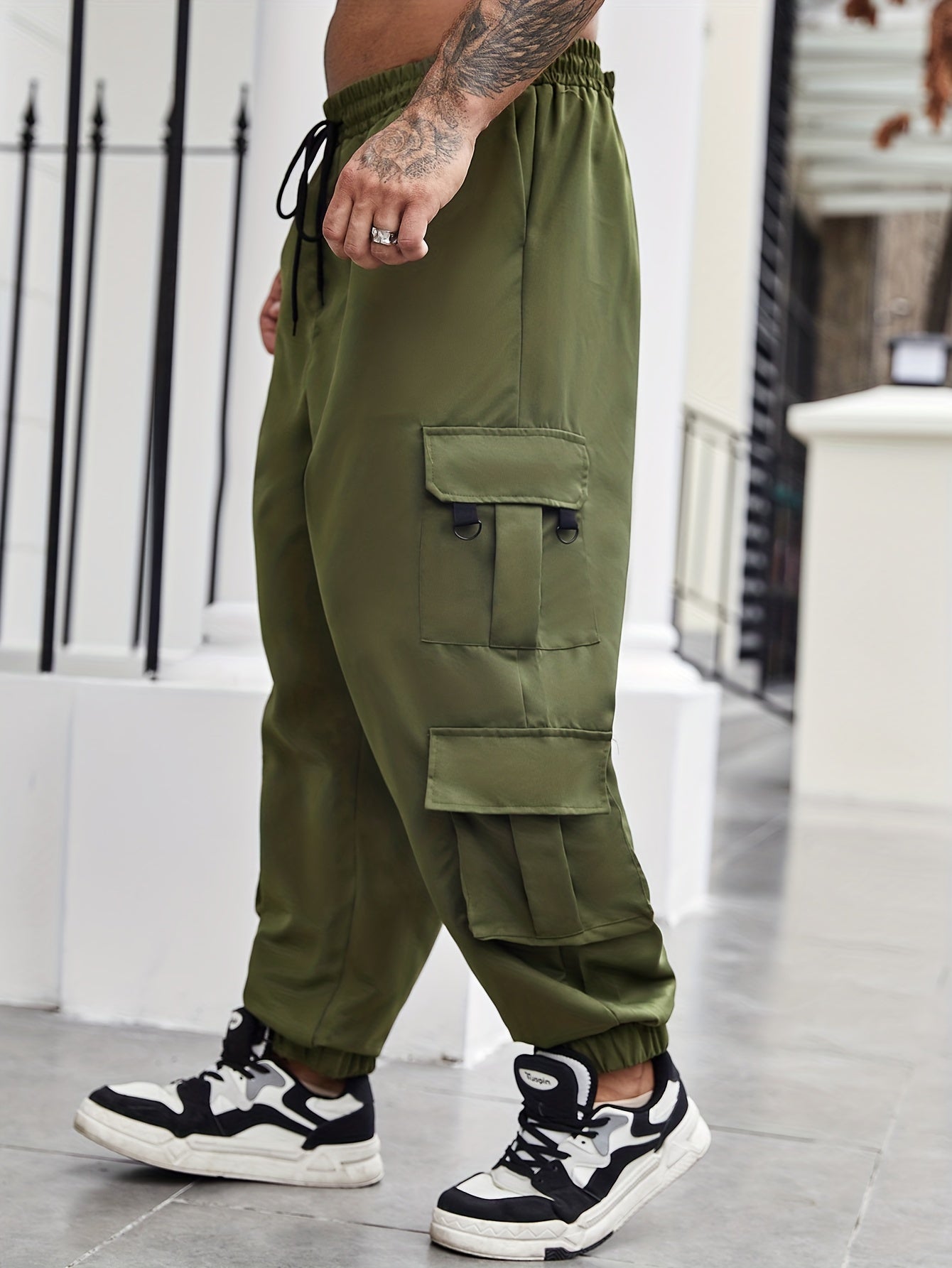 Men's plus size cargo pants with pockets for spring and fall fashion.