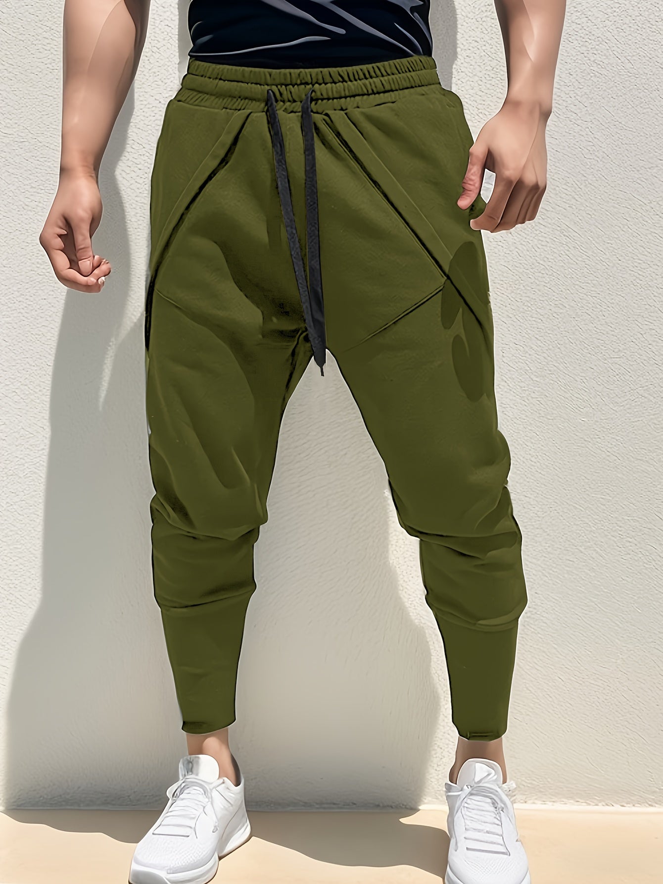 Casual style men's athletic sweatpants with tapered fit, side pockets, and adjustable drawstring for sports and relaxation.