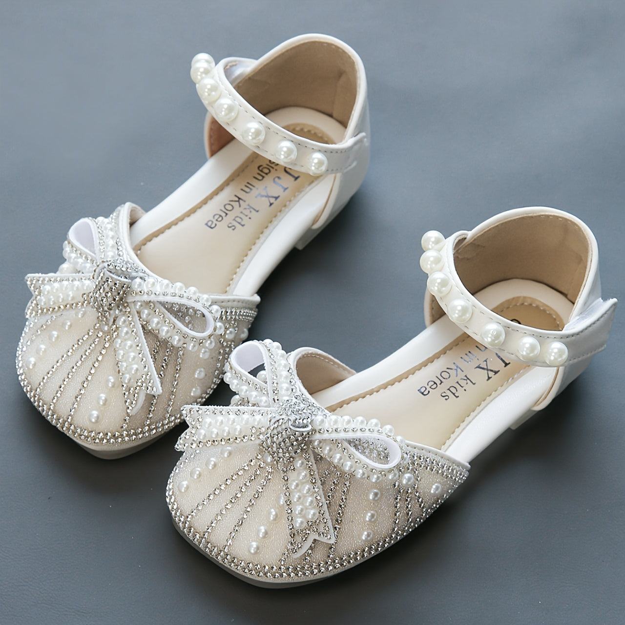 Sparkly bowknot flats with adjustable strap, durable TPR sole, comfortable for daily wear for girls aged 14 and under.