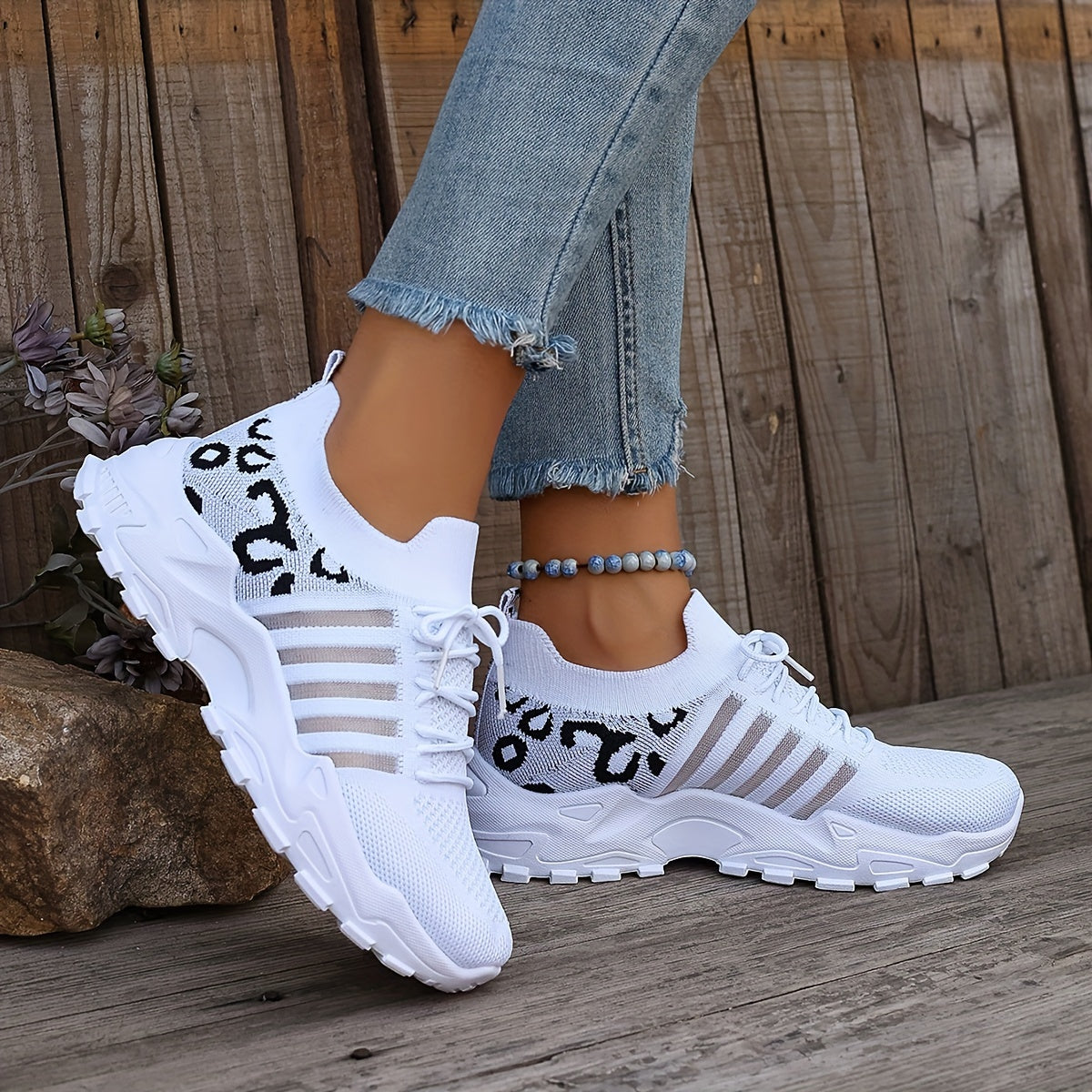 Breathable mesh leopard print sneakers with comfortable platform sole and stylish low-top design.