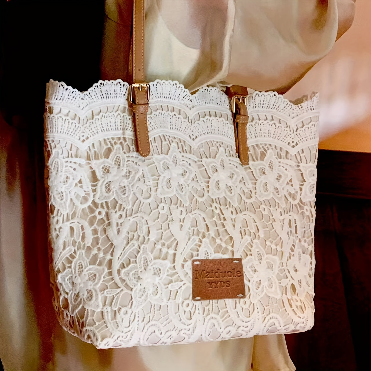 Stylish lace shoulder bag for women, with adjustable strap, foldable design, kiss lock closure, and wristlet accessory - perfect for daily use.