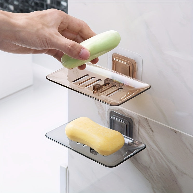 Wall-mounted soap dish with drainage, adhesive holder for bathroom organization.