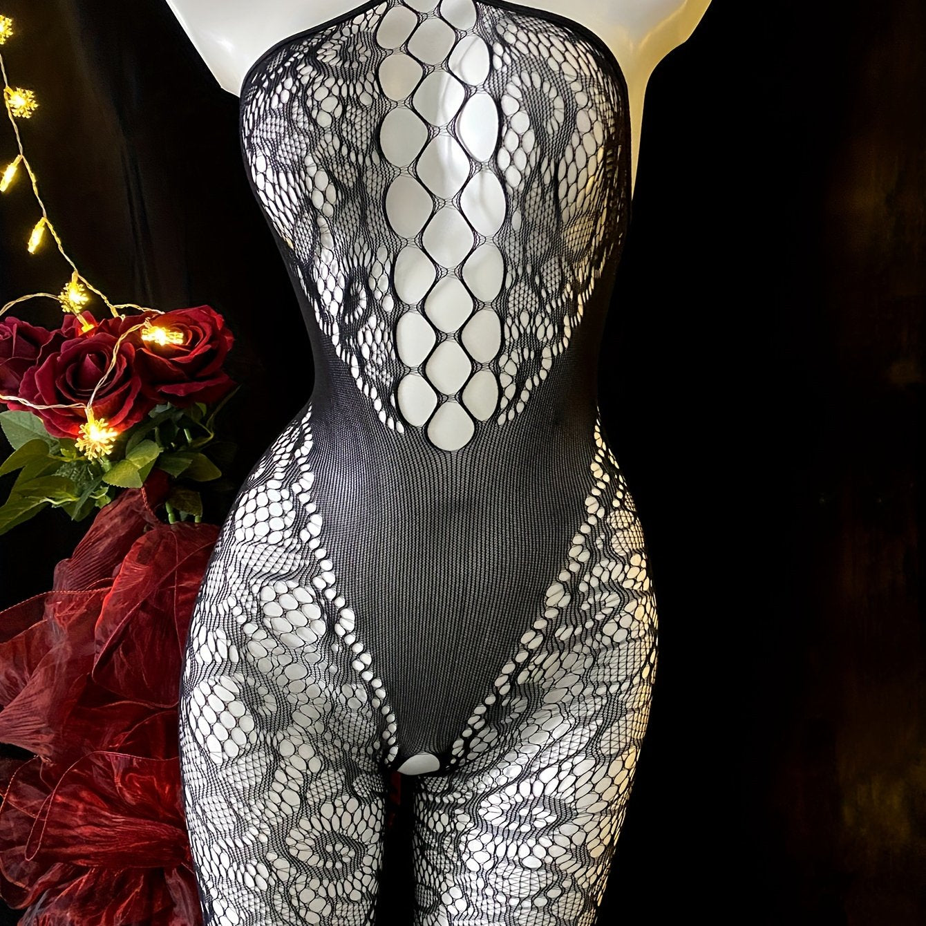 Sleeveless lace bodysuit with fishnet detail made of sheer nylon and elastane. Features high-stretch fabric and chic hollow-out design. Hand washable. For women.