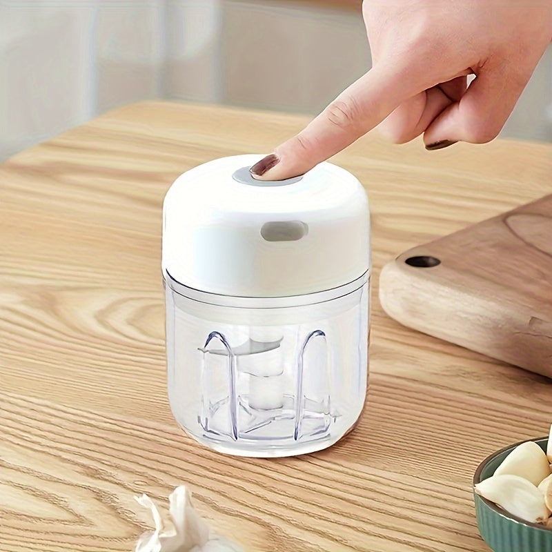 Compact electric mini food chopper with USB rechargeable battery, ideal for chopping garlic, vegetables, fruit, and meat.