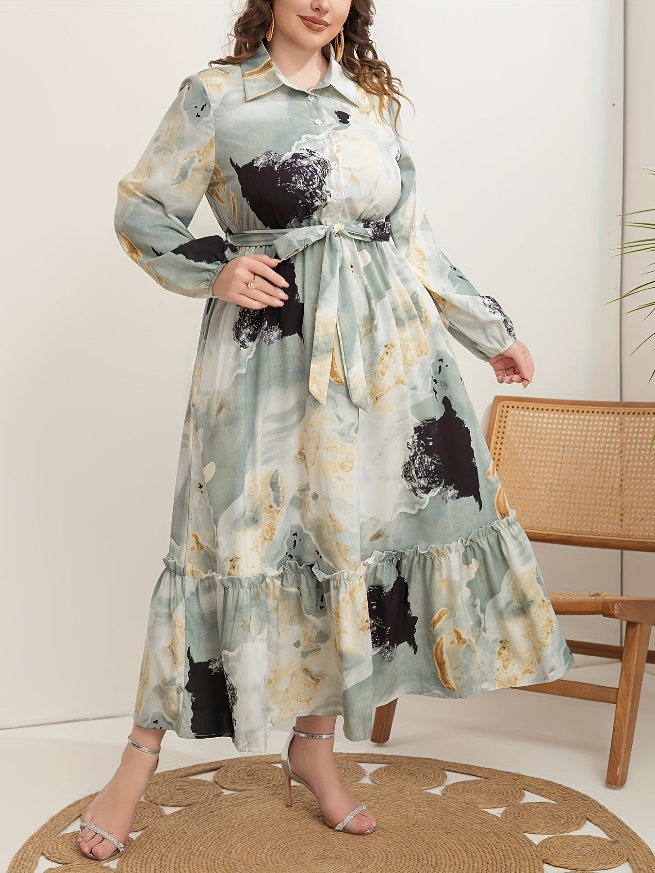 Stylish plus-size marble print dress for women features long sleeves, collar, ruffle hem, and belt. Versatile all-season fashion.