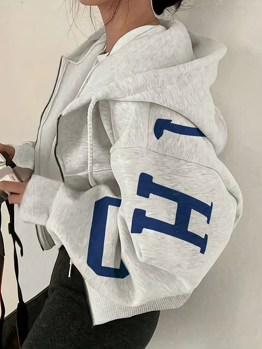 Y2K-inspired zip-up hoodie for women in light gray with blue letter print. Casual knit fabric, machine washable. Trendy crop top style, all-season jacket with a glossy texture.