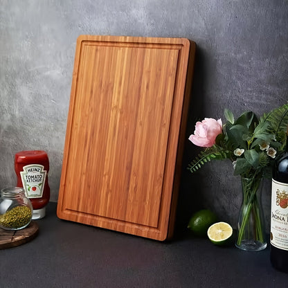 This spacious bamboo charcuterie board features convenient side handles and ample juice grooves, making it ideal for serving meats, cheeses, and deli items in the kitchen.