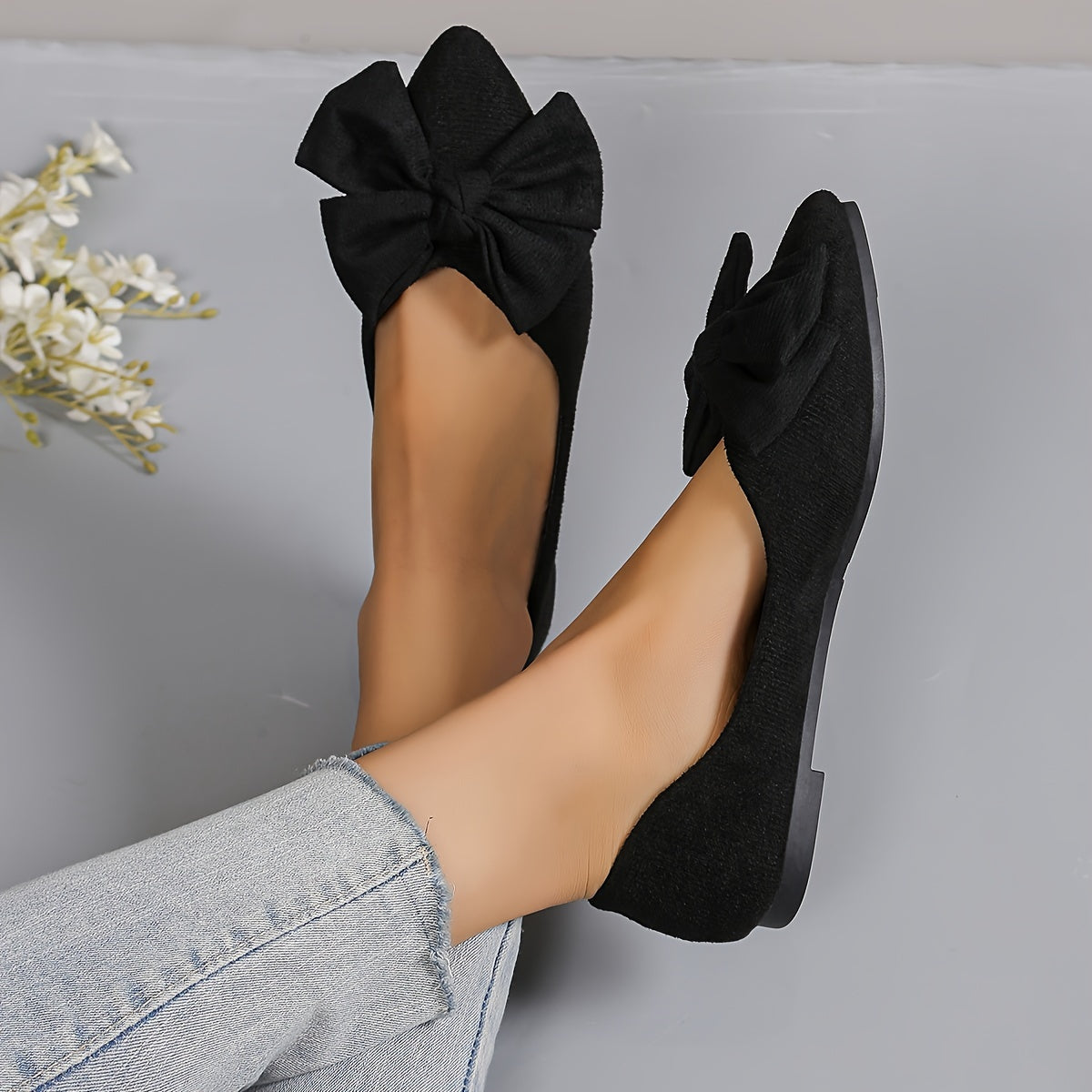 All-season slip-on flats for women with bow detail, fabric upper, rubber sole, and man-made insole. Versatile and stylish for work or casual wear.