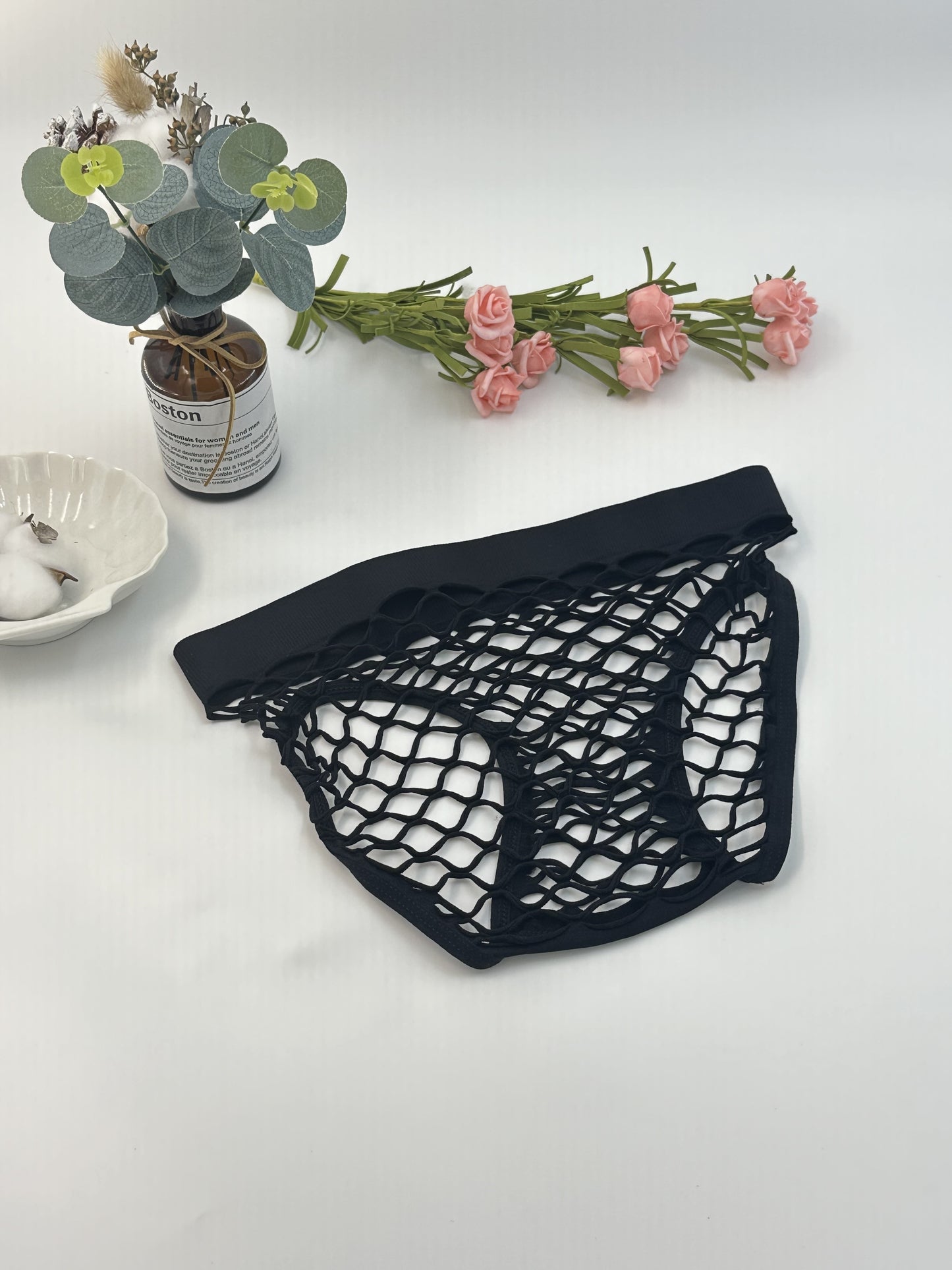 Women's sexy mesh panties made of nylon knit, with a seductive triangle brief design and seamless, breathable fabric.