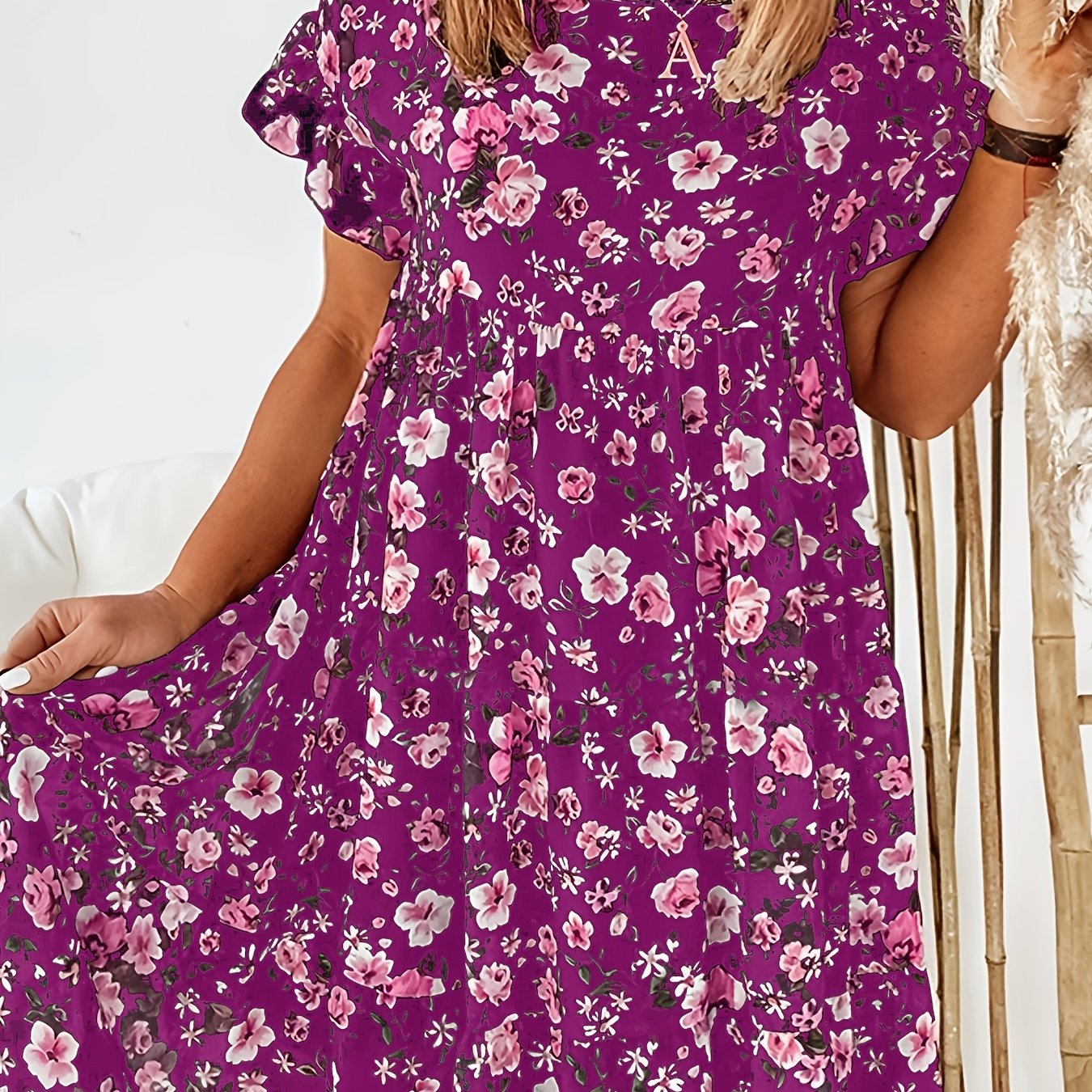 Elegant floral print plus size dress with ruffle detail. Navy blue with pink flowers, perfect for spring and summer. Casual chic style.