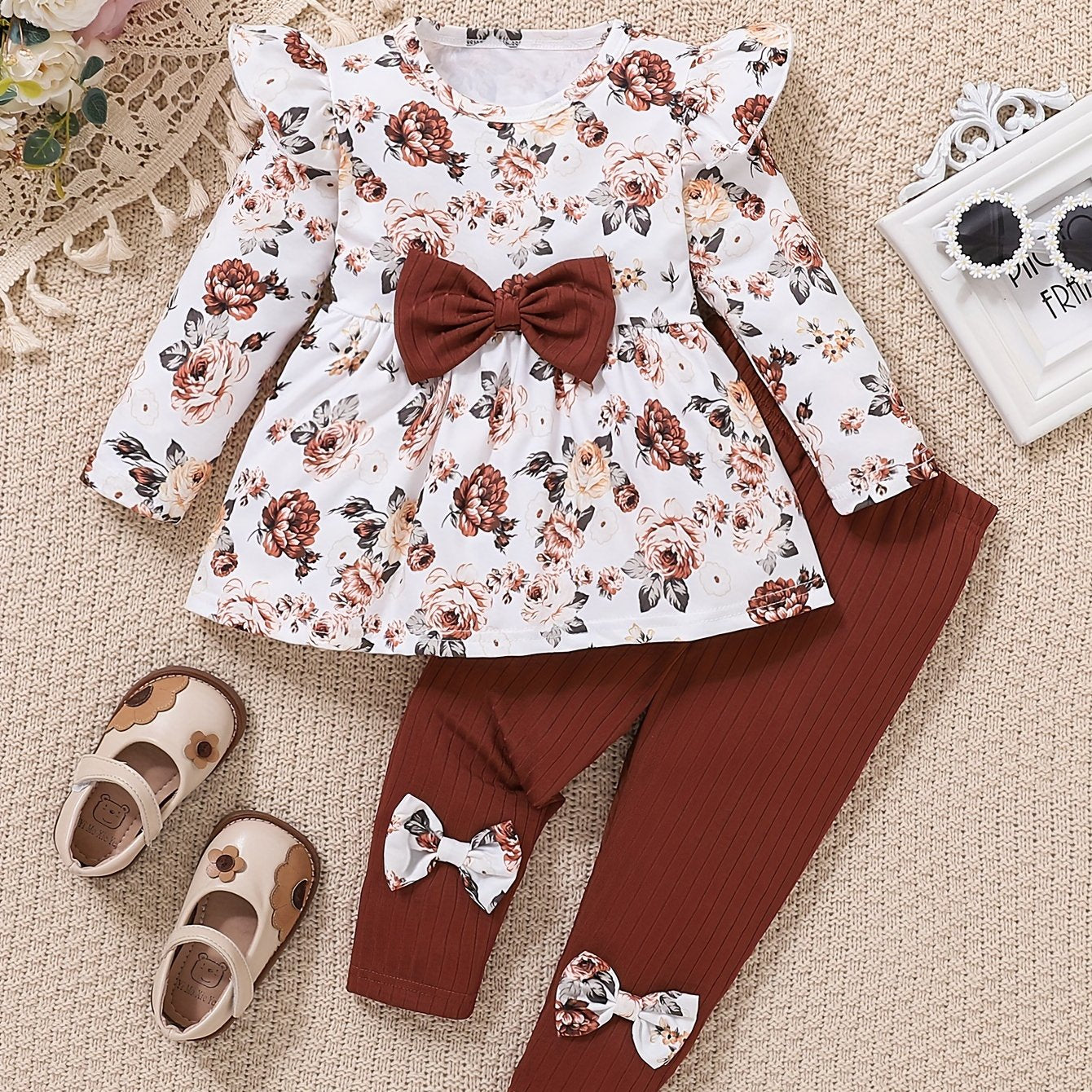 Floral print flutter sleeve top and bow-accented elastic waist pants set for girls. Comfortable knit outfit, machine washable. Made from polyester-spandex blend. Ideal for spring/fall