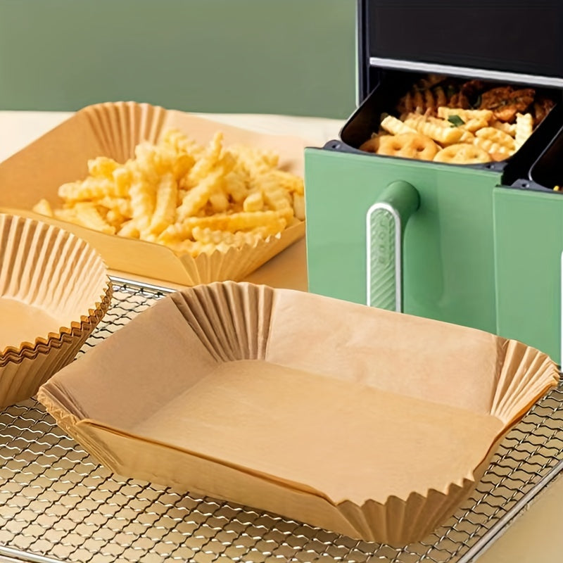 Disposable air fryer liners available in packs of 50, 100, or 200. These rectangular paper liners are designed to fit air fryer pots and basket bowls measuring 26.01cm by 16.99cm. Perfect for baking trays, ovens, and various kitchen accessories and