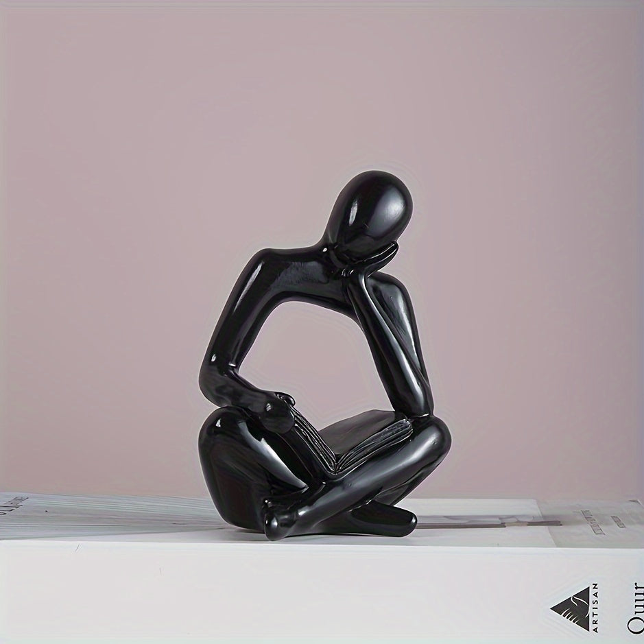 Abstract figure reading book with one hand ornament.