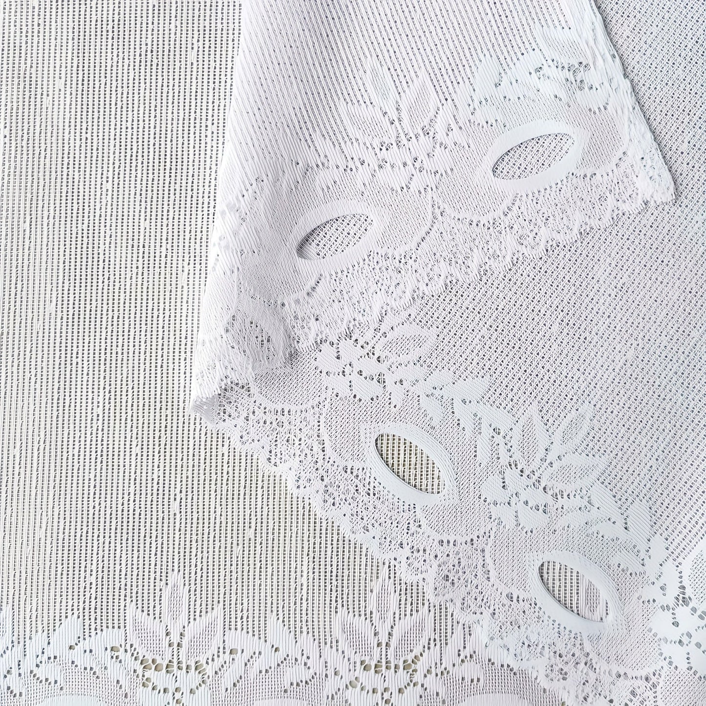 Bring elegance to your windows with our 1-piece White Lace Sheer Curtain featuring delicate floral patterns. This curtain has a rod pocket, scalloped bottom, and is made of lightweight polyester voile, perfect for dining rooms and kitchens. It is