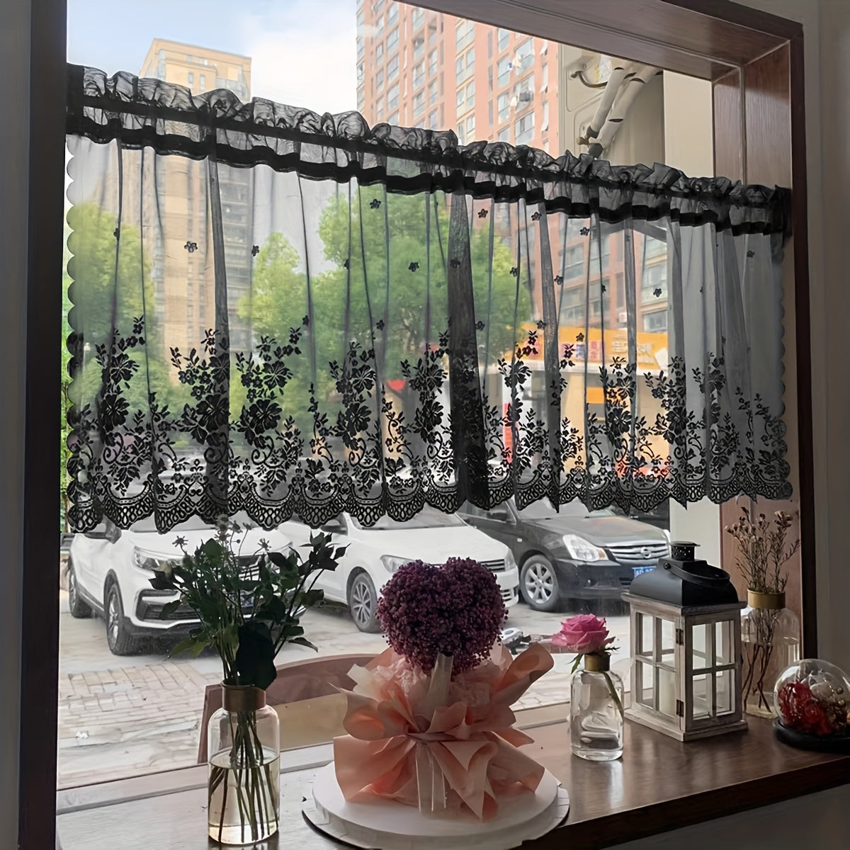 Elevate your space with this elegant black floral lace cafe curtain. Featuring a sweet and simple design, this curtain is made of sheer polyester and has a rod pocket for easy installation. Perfect for adding a touch of sophistication to your kitchen