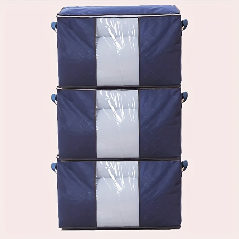 Three 90L storage bags with reinforced handles for organizing clothing, blankets, toys, and bedding in a bedroom wardrobe.