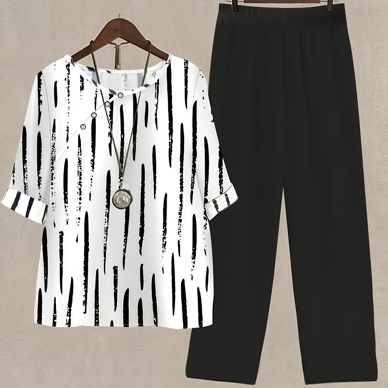 Women's Brush Print Cozy Leisure Set, including a short sleeve blouse with rolled hem and straight leg solid color pants.