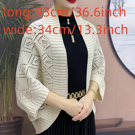 Black knit cardigan shawl for women, versatile autumn & winter wrap made of soft acrylic with three-quarter sleeves. Perfect for layering with dresses or turtlenecks.