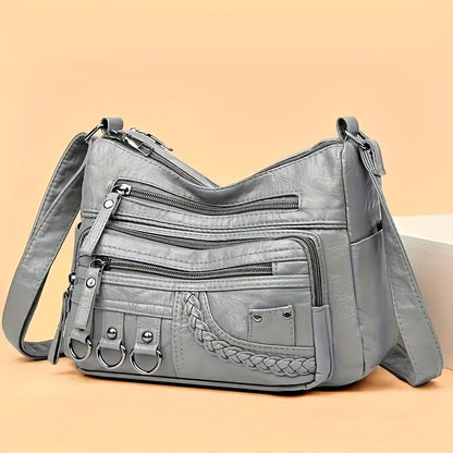 Casual black crossbody bag with multiple zippers for daily use.