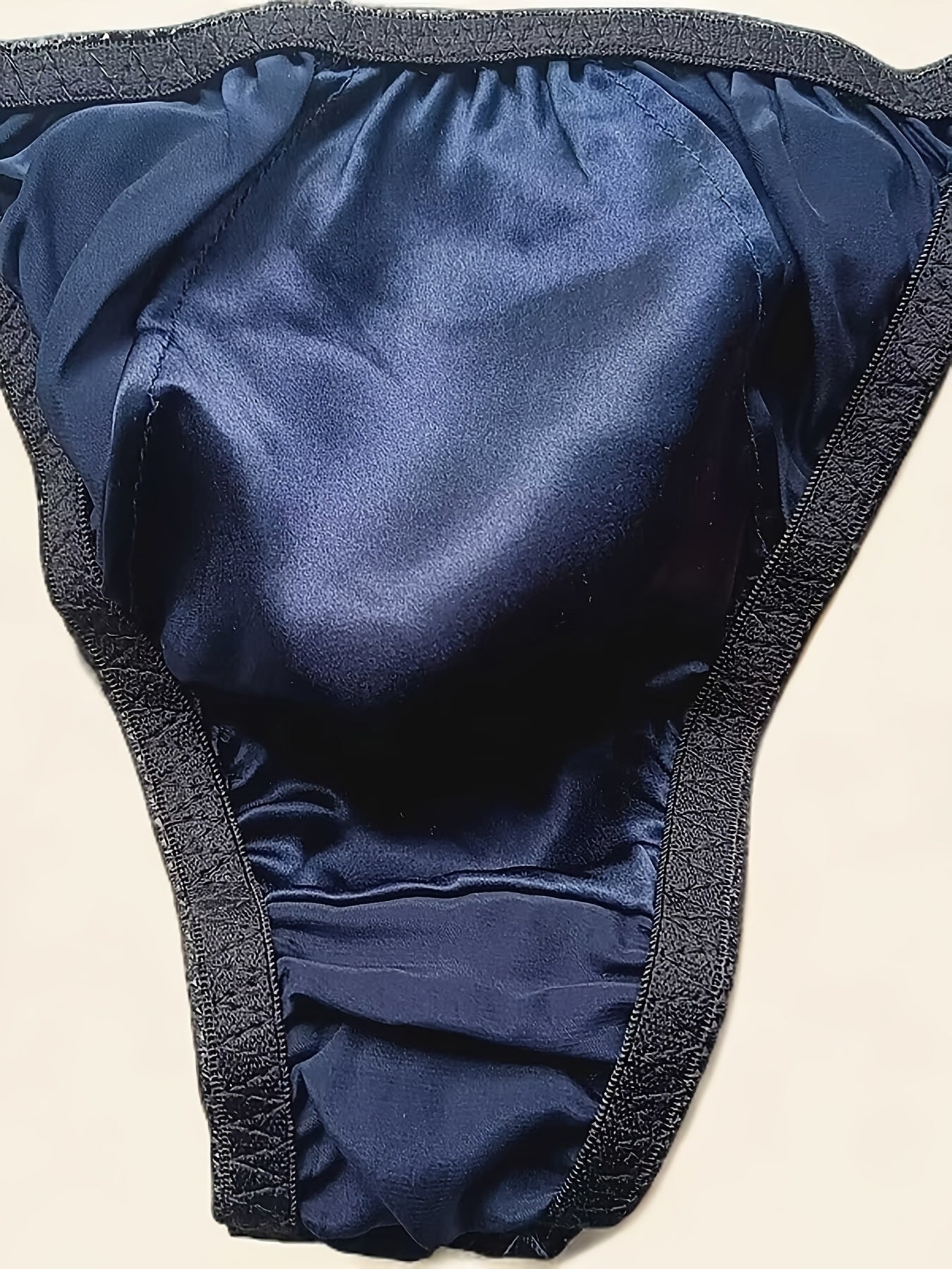 Men's Mulberry Silky Briefs are soft, breathable, non-see-through red underwear with an elastic waistband and ruffled edges. Hand wash only.