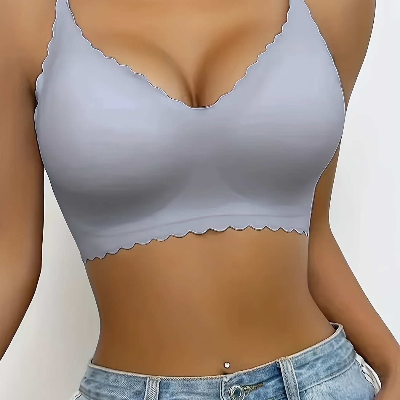 Silky nylon sports bra with V-neck, scalloped edges, no underwire, removable pads in light gray. Comfortable and supportive for casual wear.