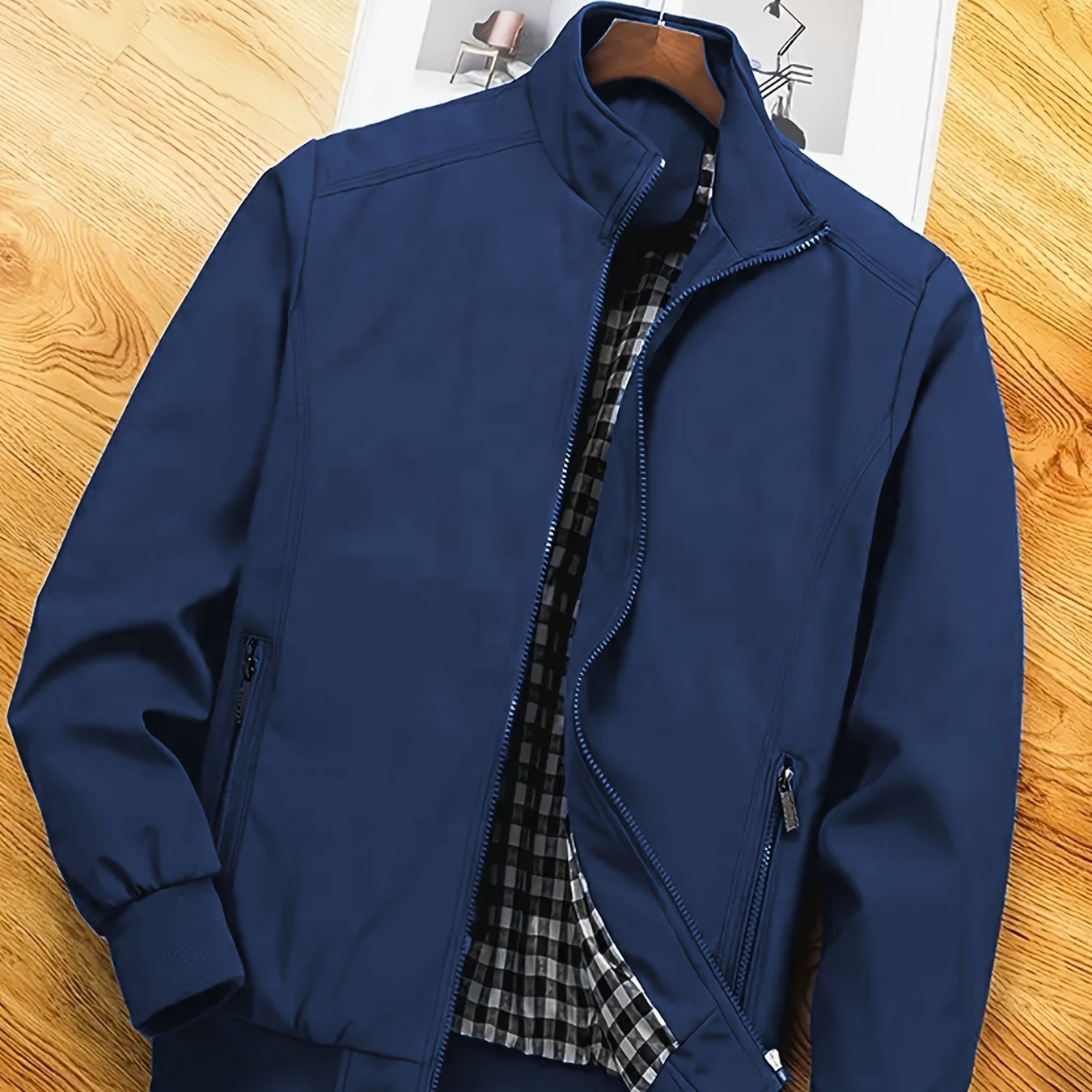 Men's casual spring/autumn polyester jacket with stand collar, zipper pockets, and solid long sleeves for outdoor and workwear.