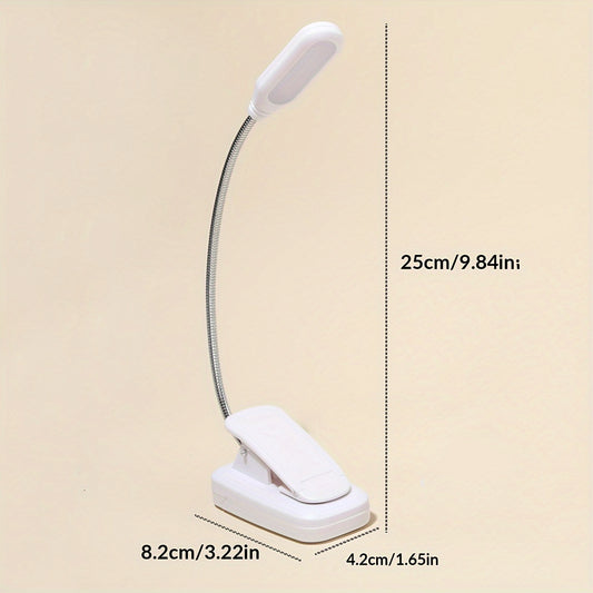 Portable white LED book light with battery power, adjustable arm, and clip for reading at night.