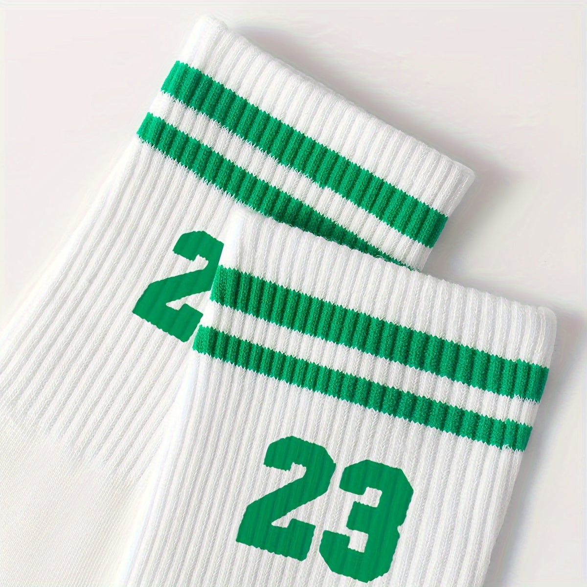 Men's athletic mid-calf socks with striped pattern featuring number 23. Made of 95% polyester and 5% spandex. Hand wash only.