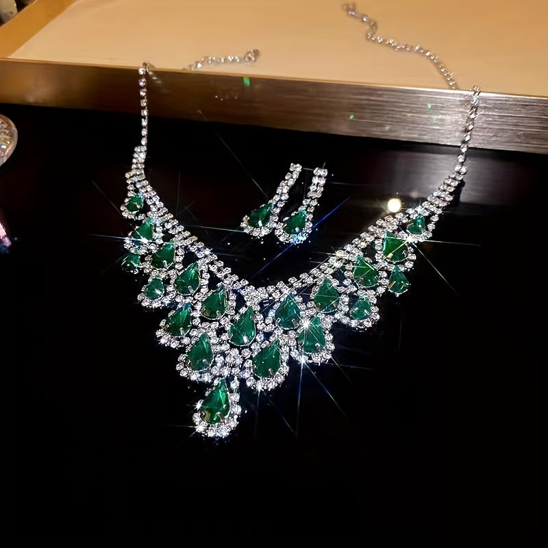 Elegantly designed in a vintage teardrop tassel style, this set features a luxurious green rhinestone necklace and matching earrings. Crafted with a copper base and plated in 18K gold, the earrings have 925 silver ear posts for a touch of sophistication.