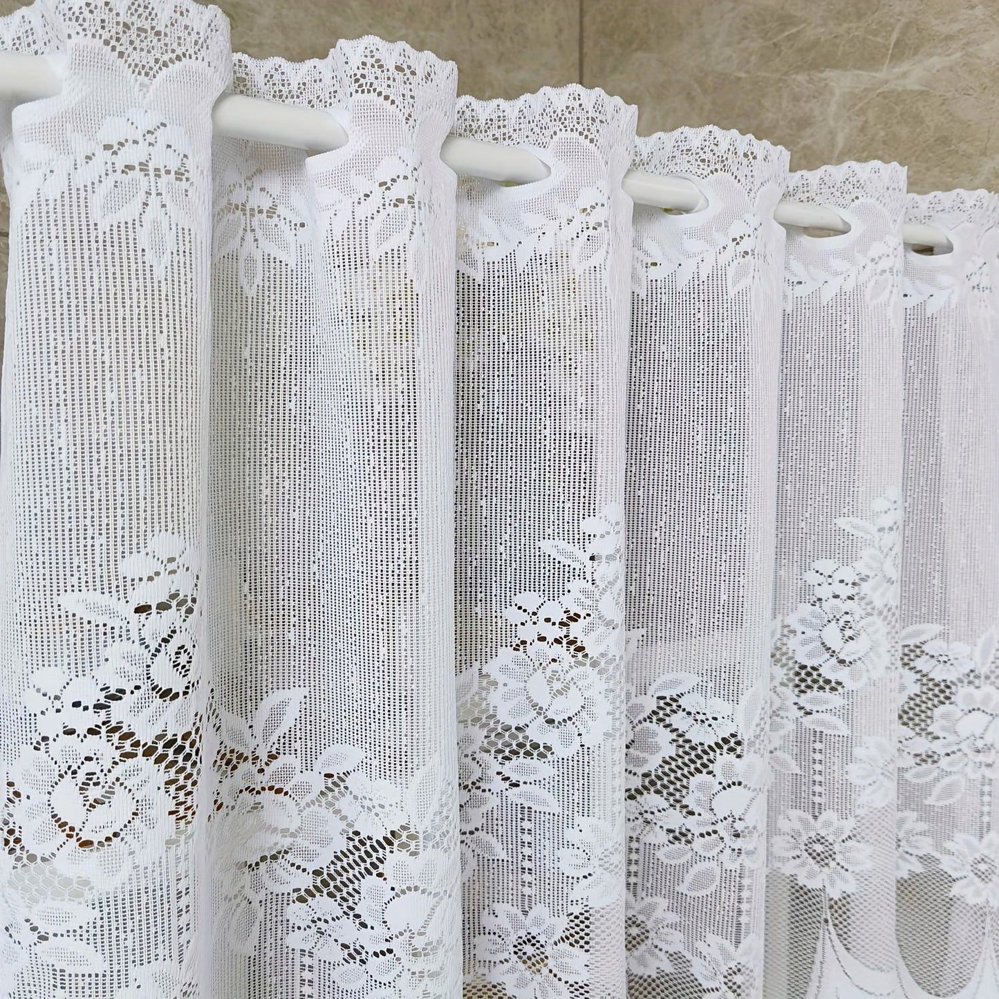 Bring elegance to your windows with our 1-piece White Lace Sheer Curtain featuring delicate floral patterns. This curtain has a rod pocket, scalloped bottom, and is made of lightweight polyester voile, perfect for dining rooms and kitchens. It is