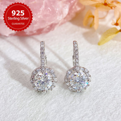 These elegant earrings feature two dazzling 1CT Moissanite round stones set in 925 sterling silver, with a total weight of approximately 2.91 grams. Perfect for weddings or as a luxurious Valentine's Day gift for your beloved.