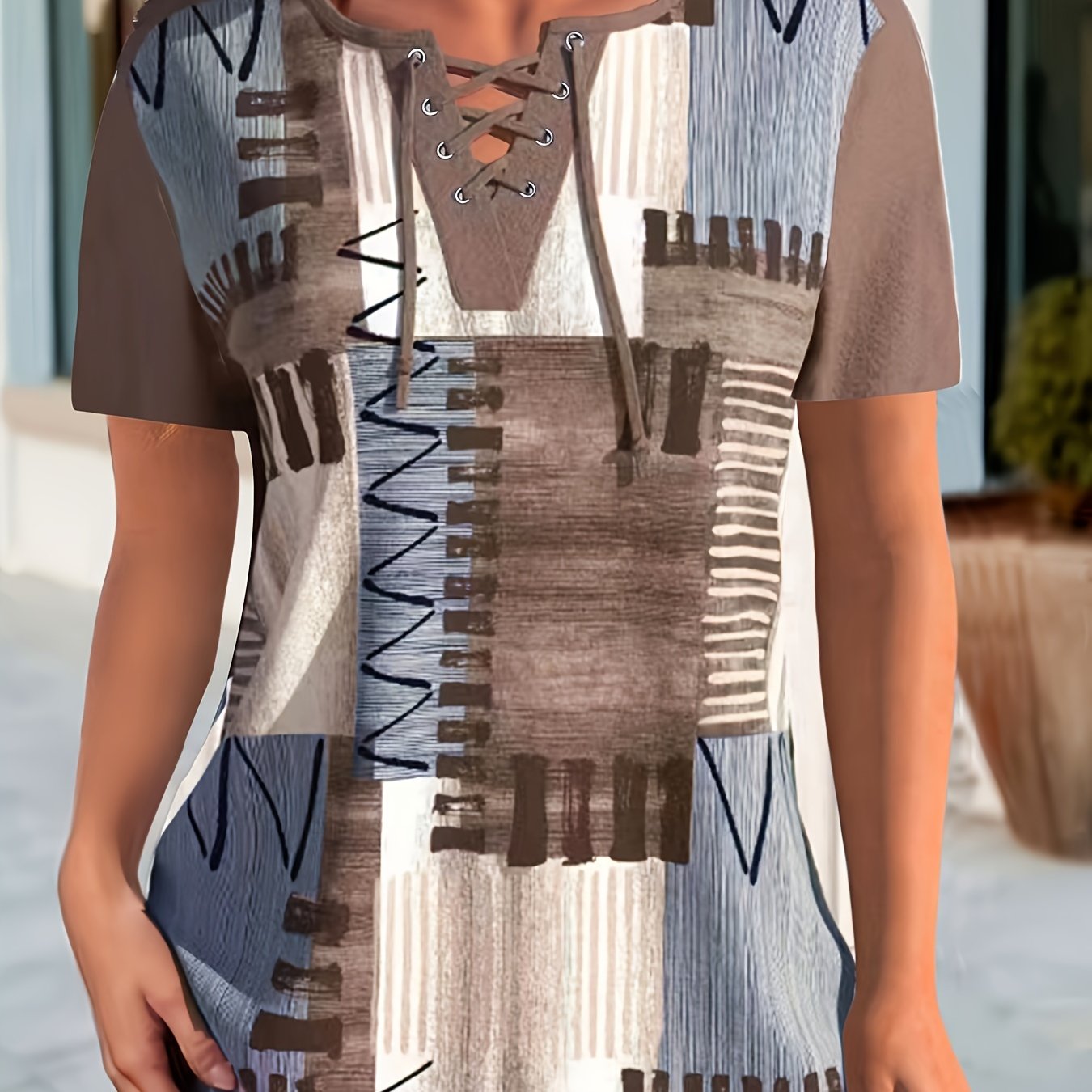 Women's casual geometric print t-shirt with lace-up detail features a v-neck, short sleeves, and stretchy polyester blend. Machine washable.