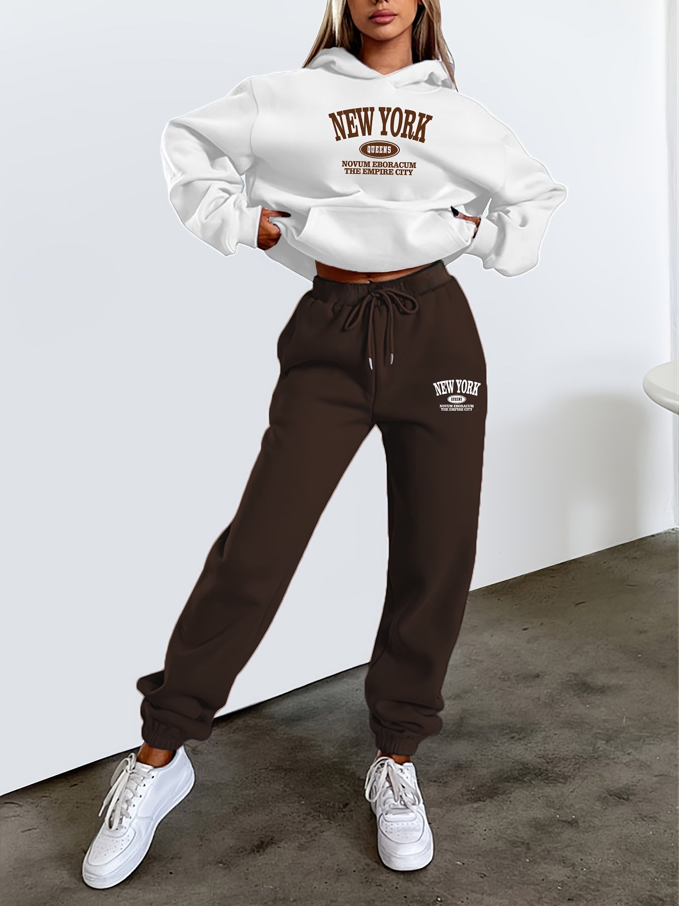 Women's casual 2-piece set featuring a long-sleeve hooded sweatshirt with drawstring and matching pants in polyester knit fabric with alphabet pattern. Suitable for all seasons, this