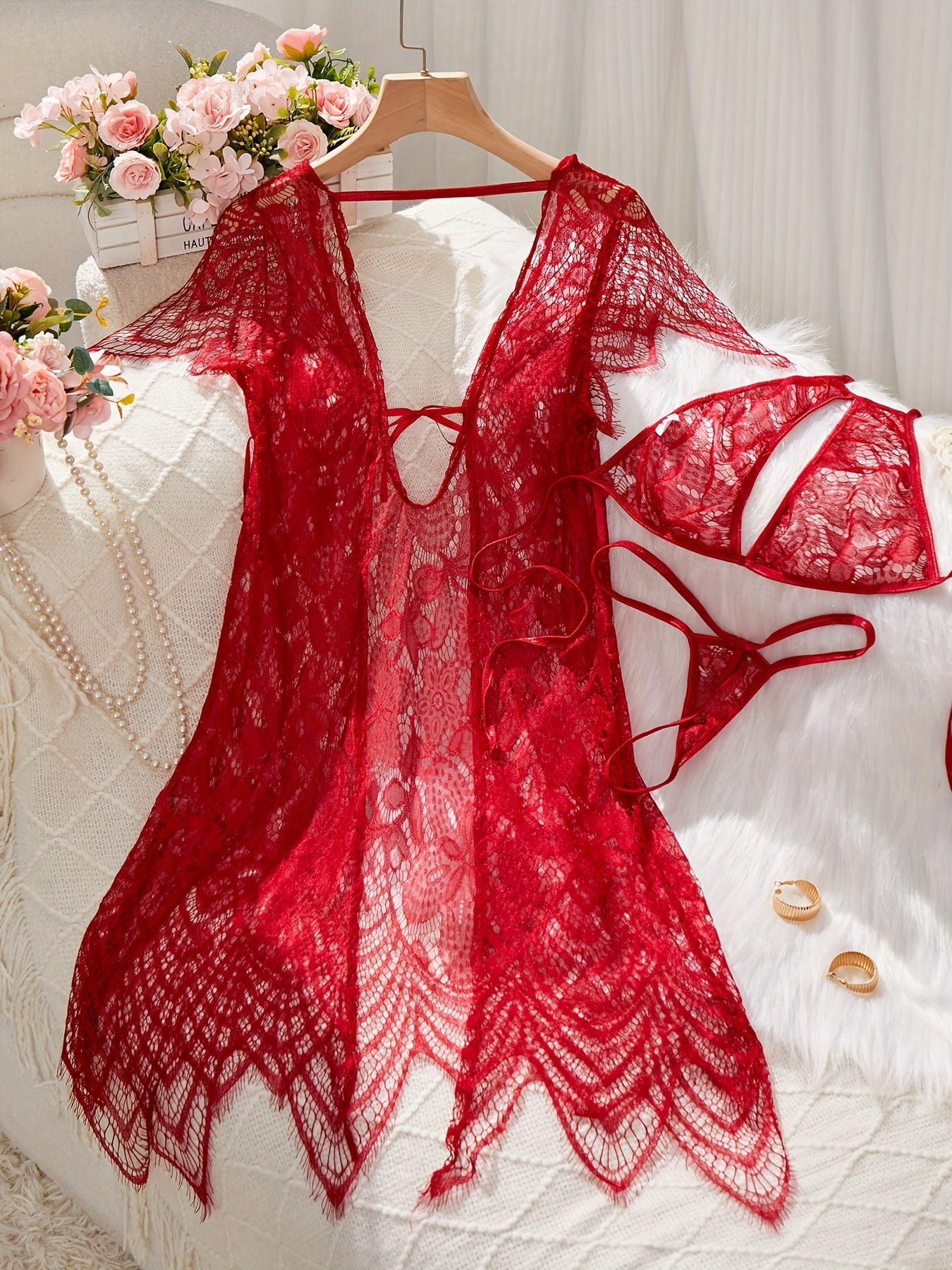 Lace lingerie set with belt and cardigan, bra, and thong for women.