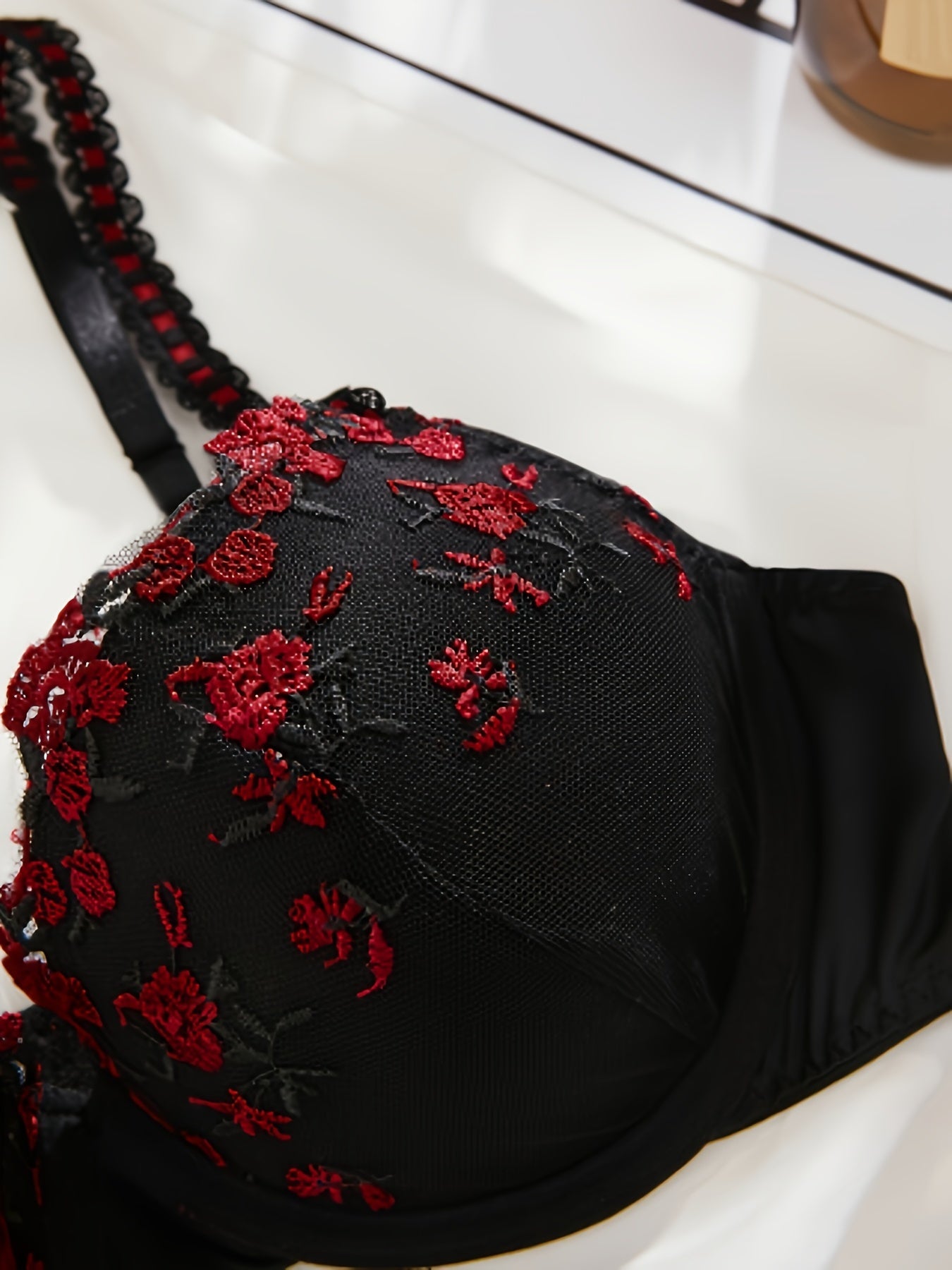 Floral embroidered honeymoon lingerie set with black half cup bra and thong for daily wear.