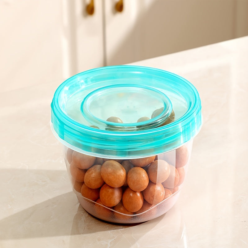 Two pieces of transparent food storage containers with blue lids - microwave safe and freshness preserving round boxes for storing grains, nuts, fruits, and more - perfect for use in home kitchens.