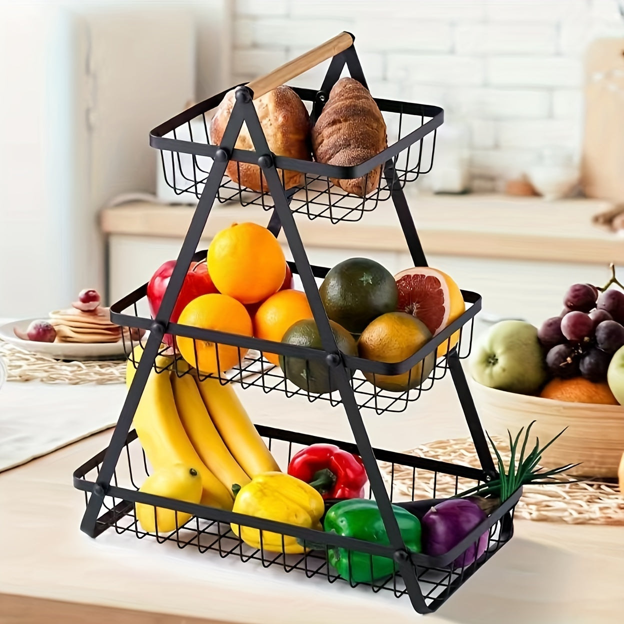 A contemporary metal fruit and vegetable basket featuring a detachable bowl-shaped storage compartment and a wooden handle for kitchen organization. Ideal for gifting during Christmas or Halloween, this handy organizer can be used on the countertop or in