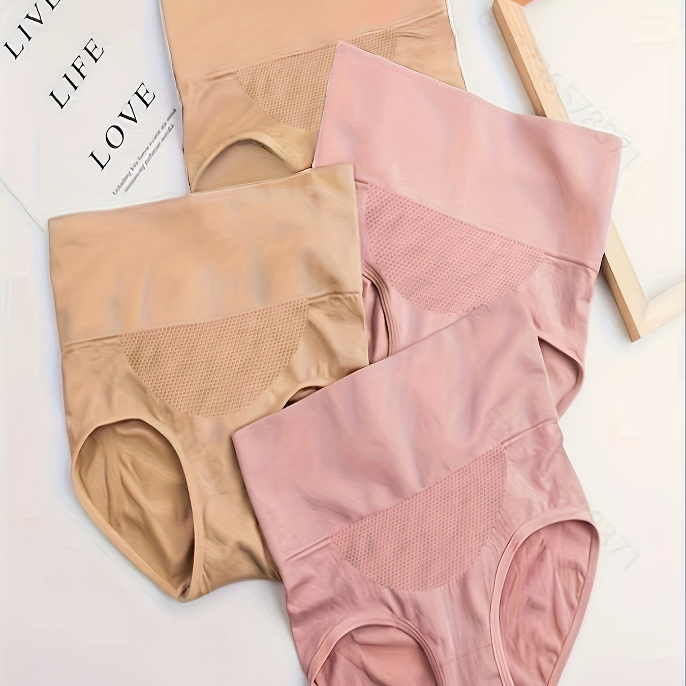 Four pieces of butt-lifting briefs with high waist, tummy control, and breathable fabric, ideal for women's lingerie and underwear.