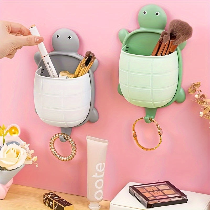 Turtle-shaped wall-mounted remote control holder with self-adhesive storage for home bathroom makeup organization.