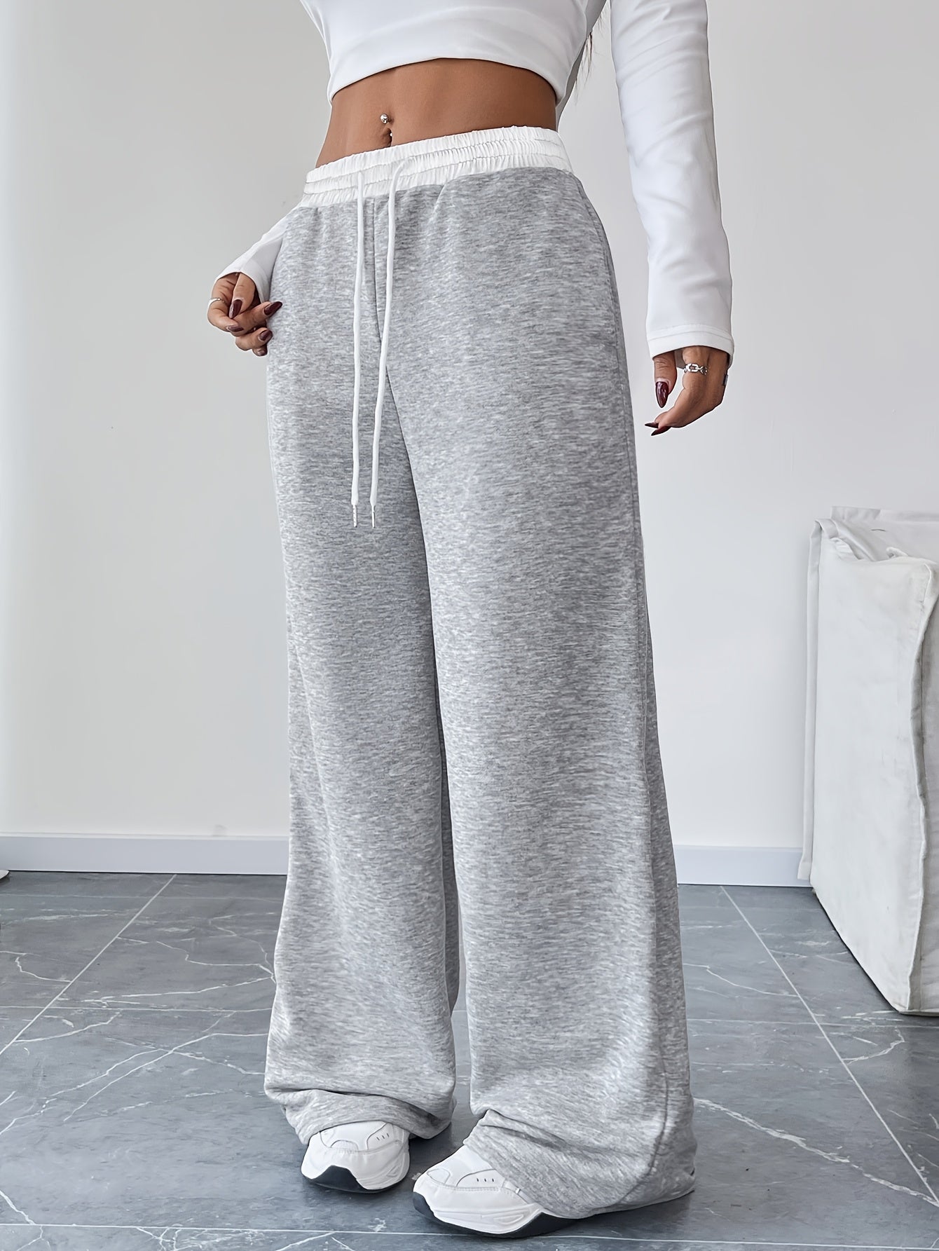 High waist wide leg drawstring pants in contrasting colors for women's spring and fall attire.