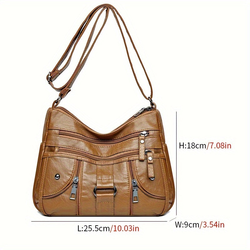 Women's synthetic leather crossbody bag with adjustable strap and anti-theft zipper closure. Large capacity with polyester lining, solid color, and multi-pocket design. Ideal for everyday