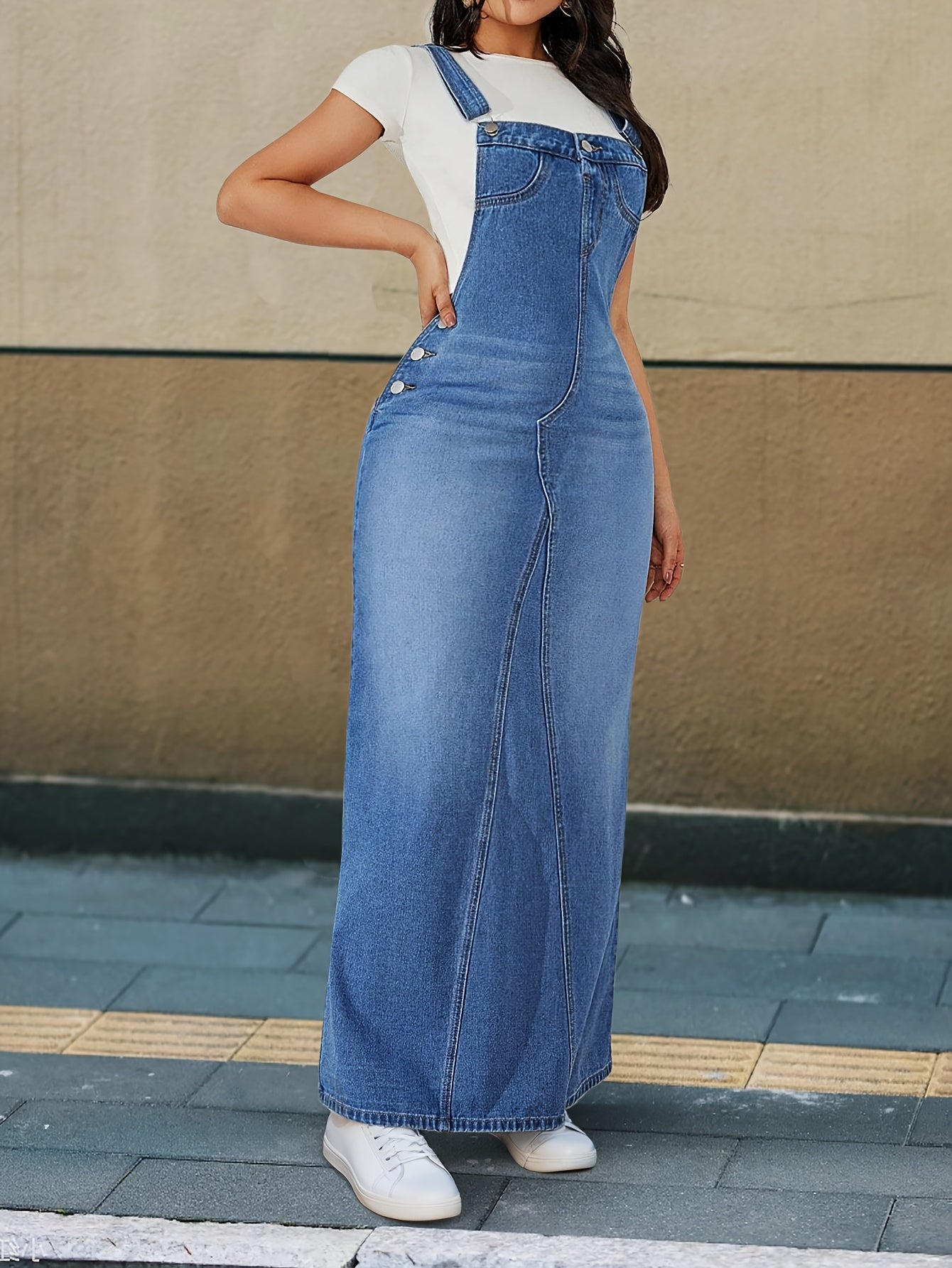 Casual denim overall dress with multiple buttons and detachable straps.