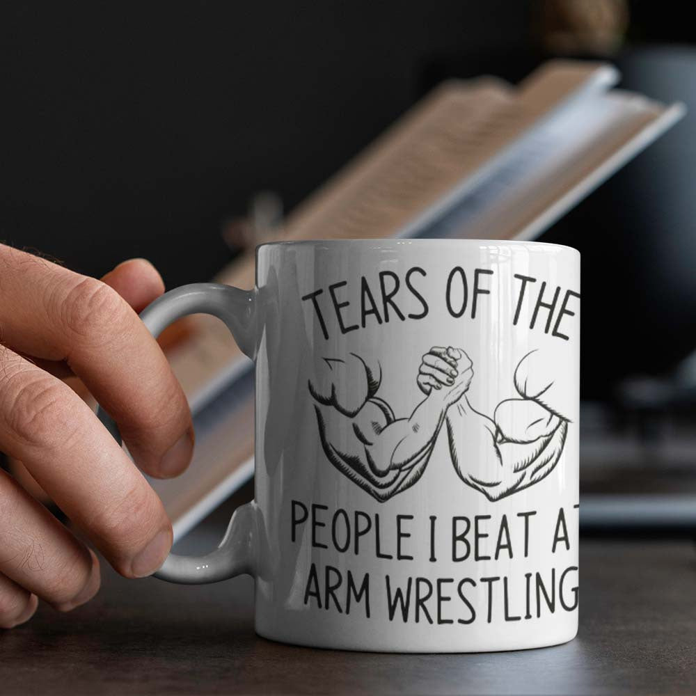 This motivational mug is perfect for arm wrestling enthusiasts. The ceramic coffee cup features a design that reads "Tears of the People I Beat" and is food-safe. It is ideal for use in the office, camping, or dining and requires no electricity to use.