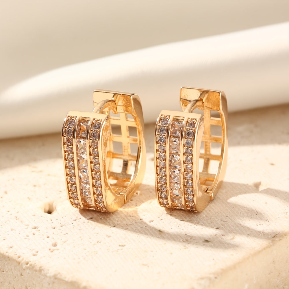 A stylish pair of MKOPSZ hoop earrings, featuring classic design and crafted with copper and synthetic zirconia. These earrings, representing the April birthstone, are perfect for both daily wear and special occasions. Inspired by a campus holiday theme